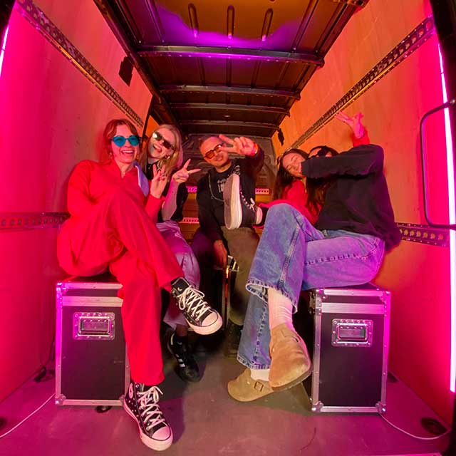 production bureau staff members dressed as barbies for international woman day in van